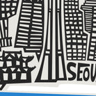 A close-up of a black and white graphic print featuring stylized city skyscrapers and the partial text 'SEO', with a small blue strip visible along the bottom edge.