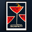Cosmopolitan cocktail print with three bold red glasses, each styled with a minimal face illustration and citrus twist, framed on a rich ochre background.