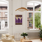 Dirty Martini poster framed above a bright window nook with light wood floors and leafy indoor plants.