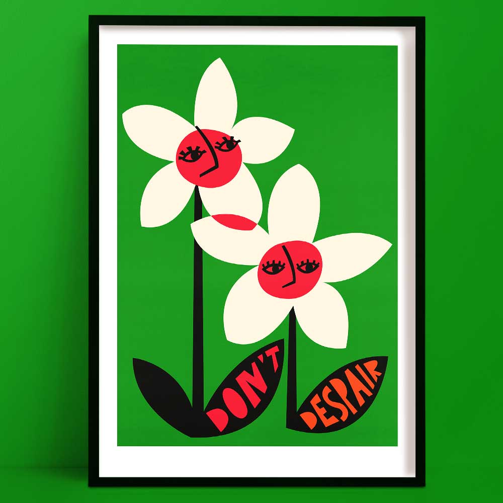 Don’t Despair flower art print with bold white petals and pink smiling faces, framed on vibrant green background.