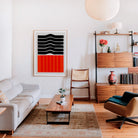 Ember art print framed in a stylish living area, with its striking colour blocks and simple form providing a graphic focal point in a cosy contemporary home.
