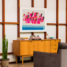 Bold flamingo art displayed in a mid-century styled home office for a quirky, modern touch.