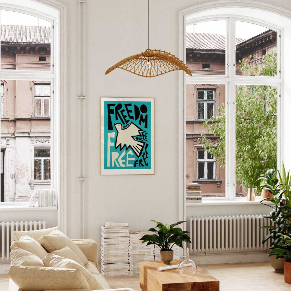 Freedom dove print framed above cream sofa in bright room with large windows and indoor plants