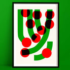 A striking abstract art print titled “Green Grass,” featuring bold red and black halftone circles cascading over curved green paths on a clean ivory background.

