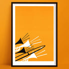 Framed abstract brass instruments print featuring trombones and trumpets in black and white on a vivid orange background