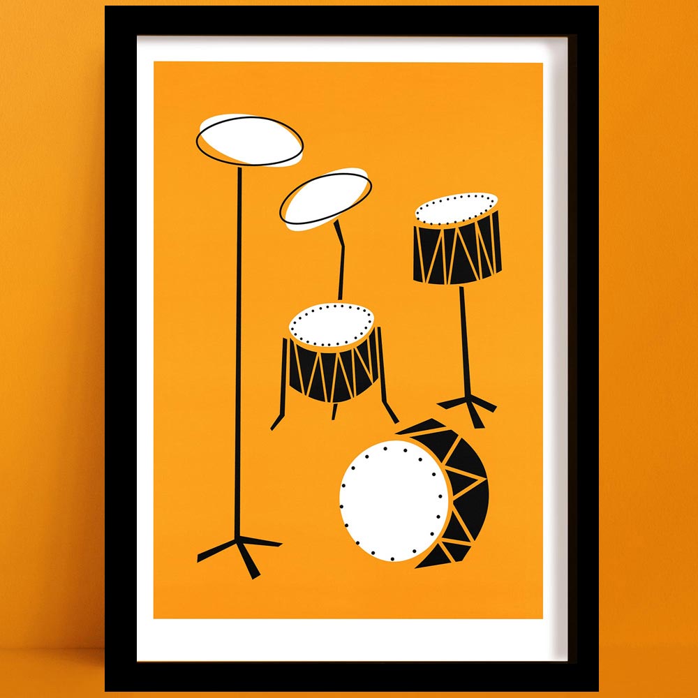 Framed abstract drum kit print with bright orange background and stylised black-and-white drums, displayed on an orange wall