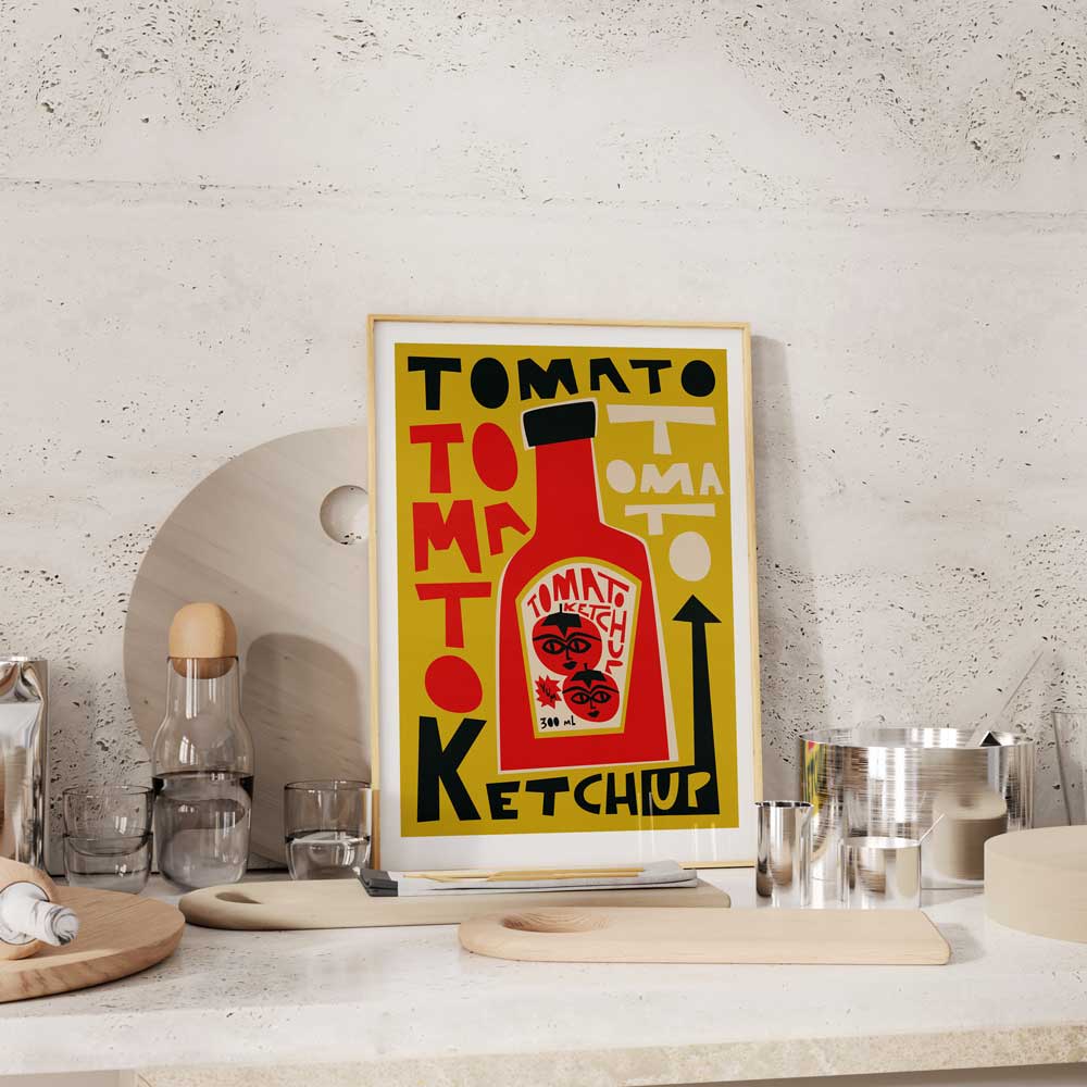 The Tomato Ketchup print hanging above a white tiled kitchen counter, adding a pop of colour and vintage charm to the modern, minimalist kitchen space.
