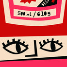 Close-up of the Tomato Ketchup bottle showing stylised face and hand-drawn text detail.