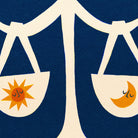 Close-up of the Libra artwork showing sun in one scale and crescent moon in the other with textured blue backdrop.