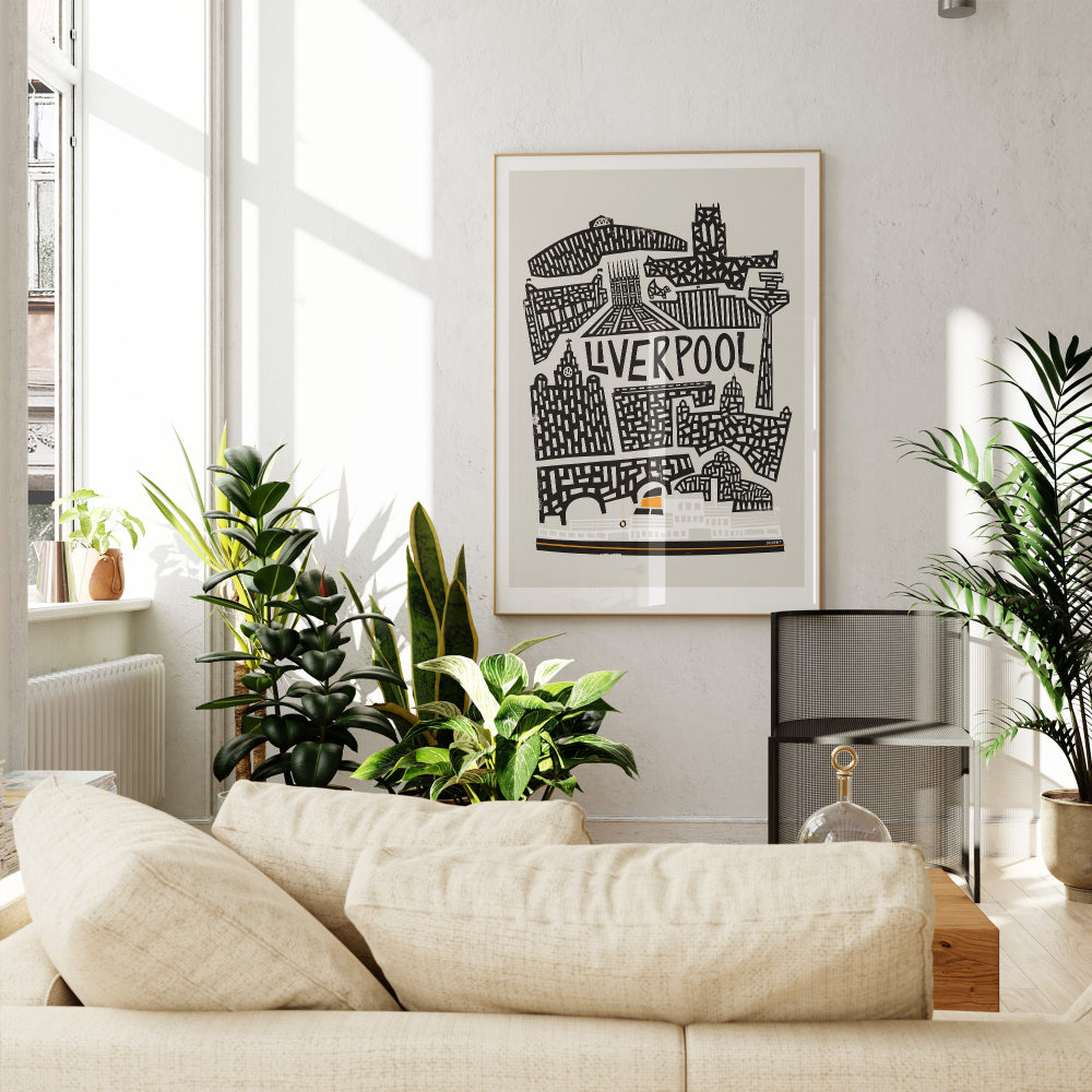 Liverpool print framed above a light sofa surrounded by greenery, adding a monochrome pop of character to the interior with a hint of coastal charm.
