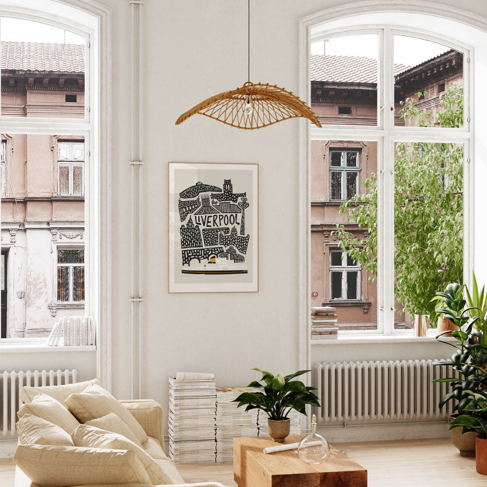 Framed Liverpool skyline artwork displayed by a window with soft natural light, bringing a modern graphic touch to a bright living space.