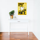 Framed Love & Hope poster adding a burst of positivity to a modern gallery-wall living room