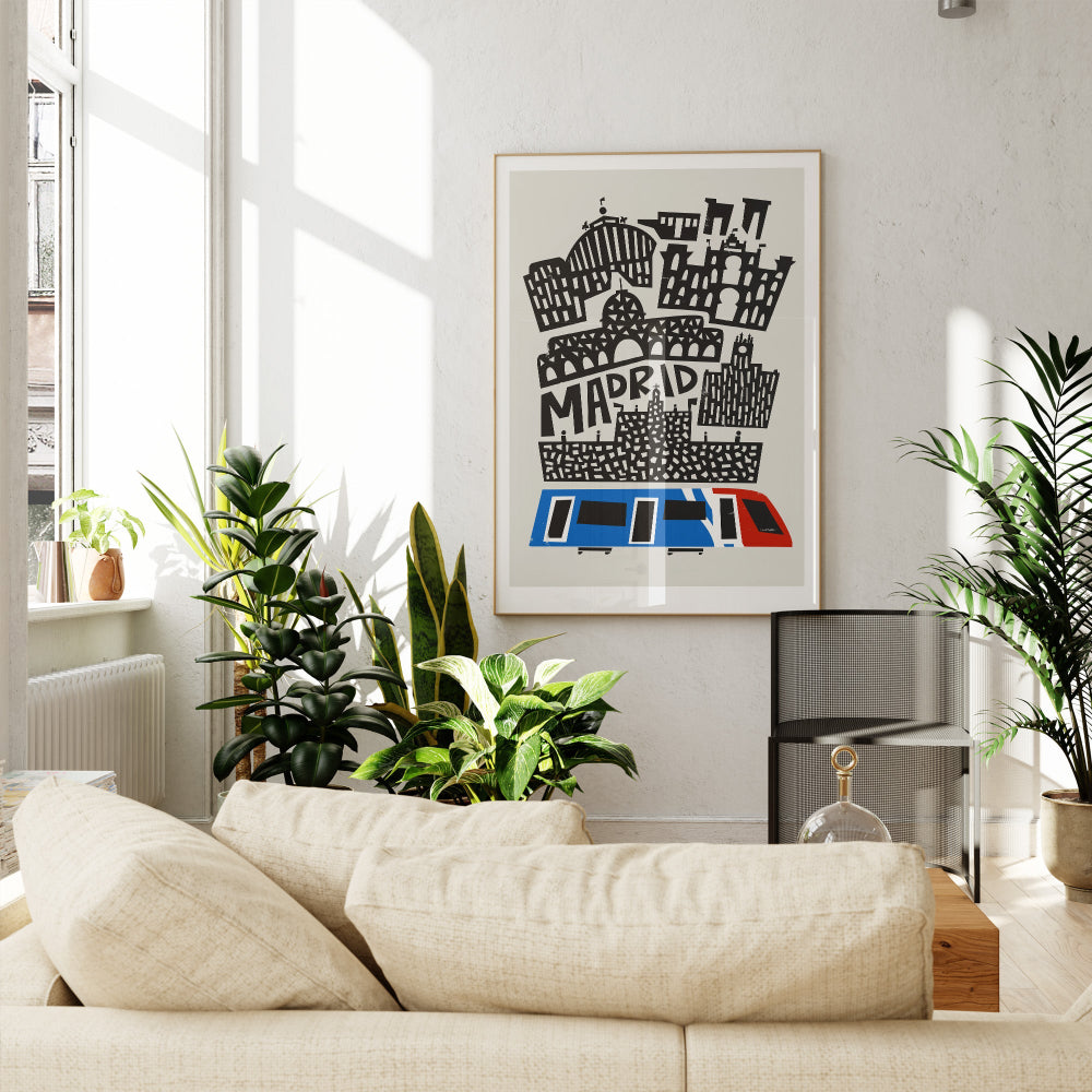 Madrid city print framed above a soft cream sofa and surrounded by greenery in a modern, relaxed setting.