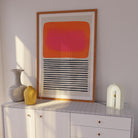 Contemporary print leaning on a cabinet, combining painterly warmth with structured linework 