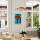 The framed print hangs confidently in a modern living room, its bold colours and cheeky expression adding personality to the space.
