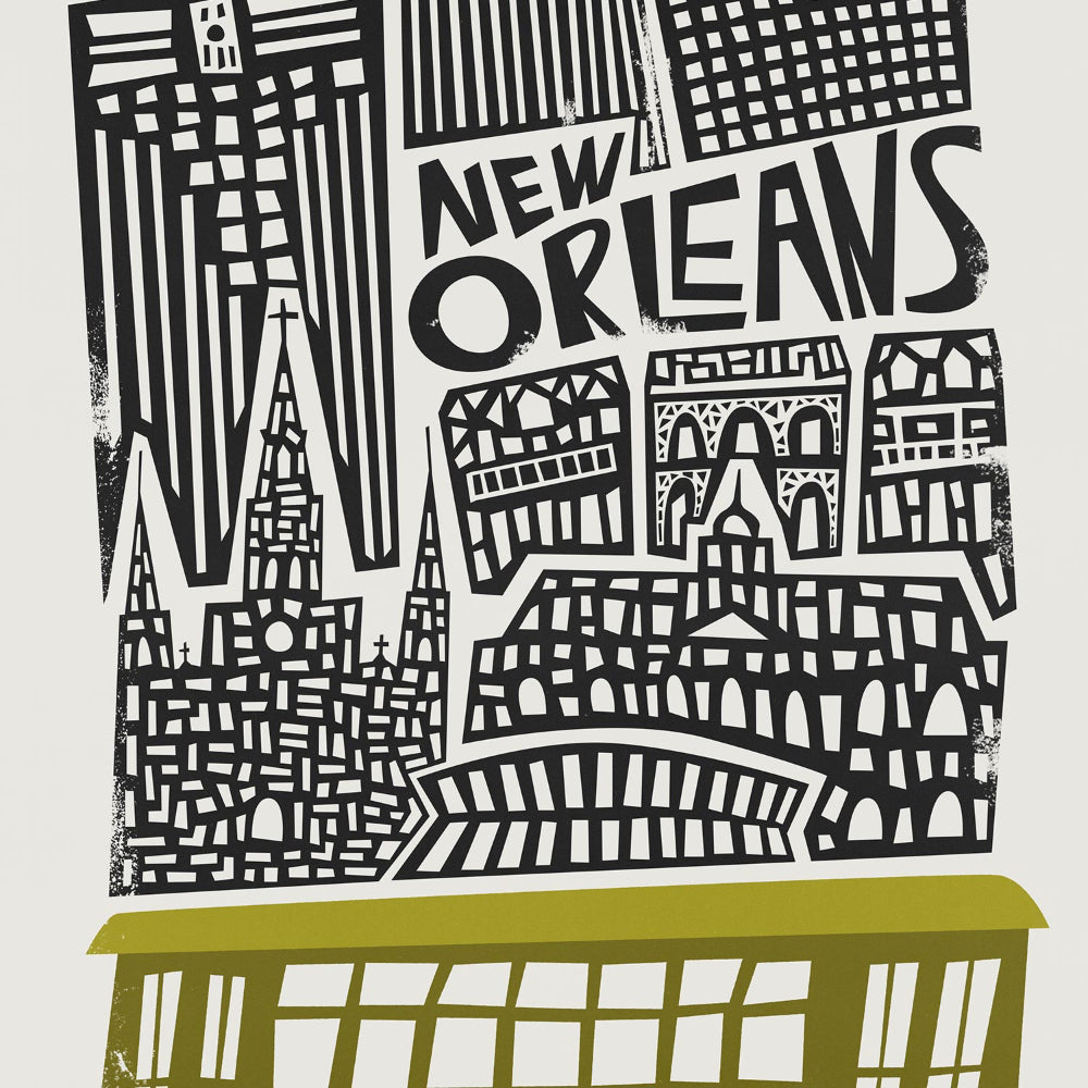 A close-up showcasing the stylised architecture and ornate lettering of “New Orleans,” sitting above the city’s iconic vintage streetcar in olive green.