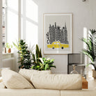 The NYC skyline print with yellow cab is displayed above a neutral sofa, adding a splash of colour and big-city energy to the contemporary space.
