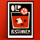 Old Fashioned cocktail art print with a bold glass illustration, abstract orange slice and star anise shapes, framed on a deep terracotta wall.