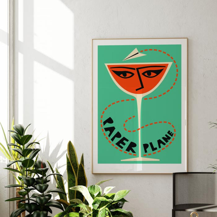 paper plane cocktail art print green and black cocktail print with mid-century styling in modern apartment