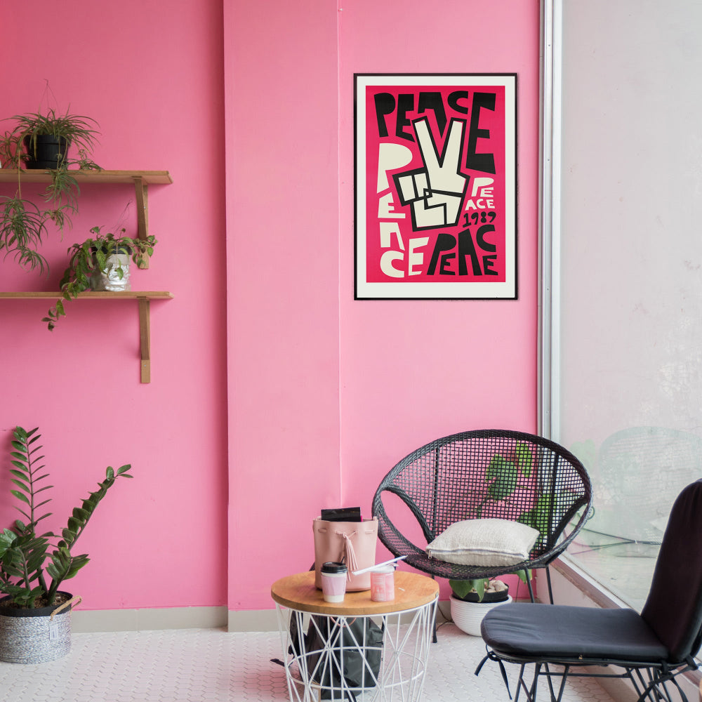 Framed Peace poster adding vibrant retro vibes to a modern living-room gallery wall-in-pink