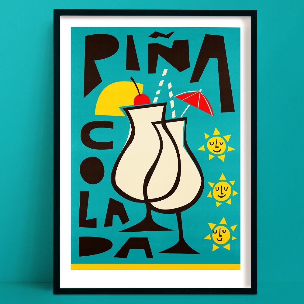 Fun piña colada art print with playful type, cherry-topped drink, and smiling suns, framed on teal wall.