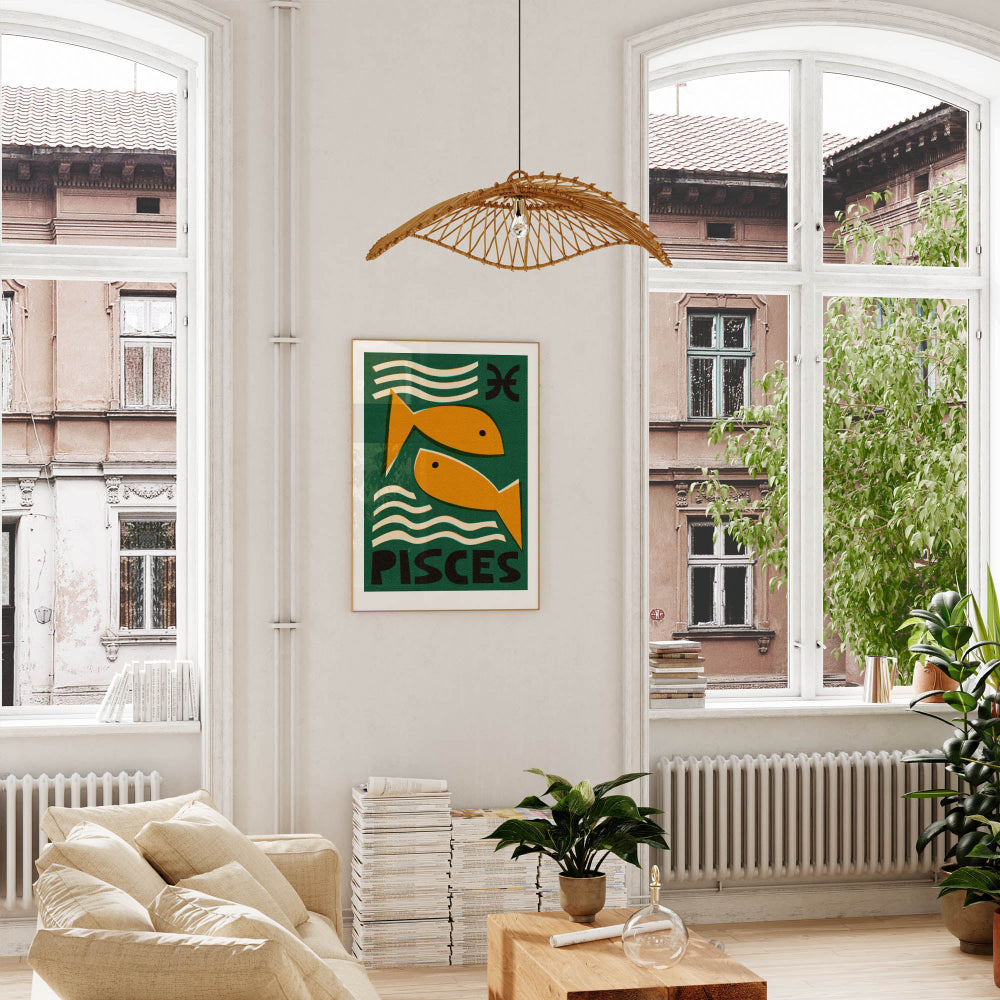 Pisces artwork framed above a low sofa in a bright room with high windows, indoor plants, and natural textures.