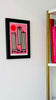 Blush pink grapefruit drink illustration framed hanging next to shelf