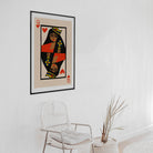 Queen of Hearts print framed on clean white wall with natural chair and dried botanical styling