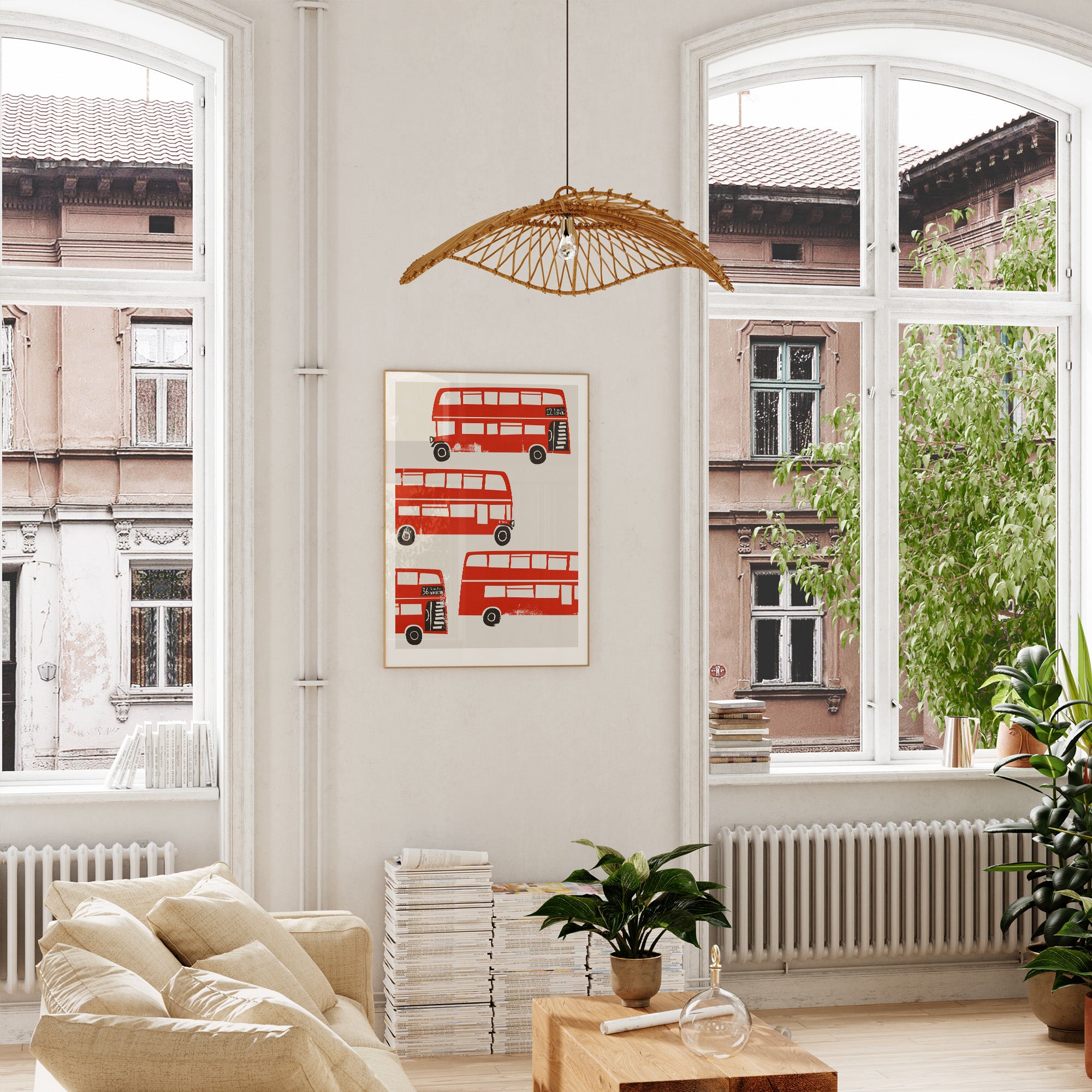 Mid-century red bus illustration framed and hanging in a tall, airy room with arched windows, adding a bold hit of colour to the calming neutral décor.
