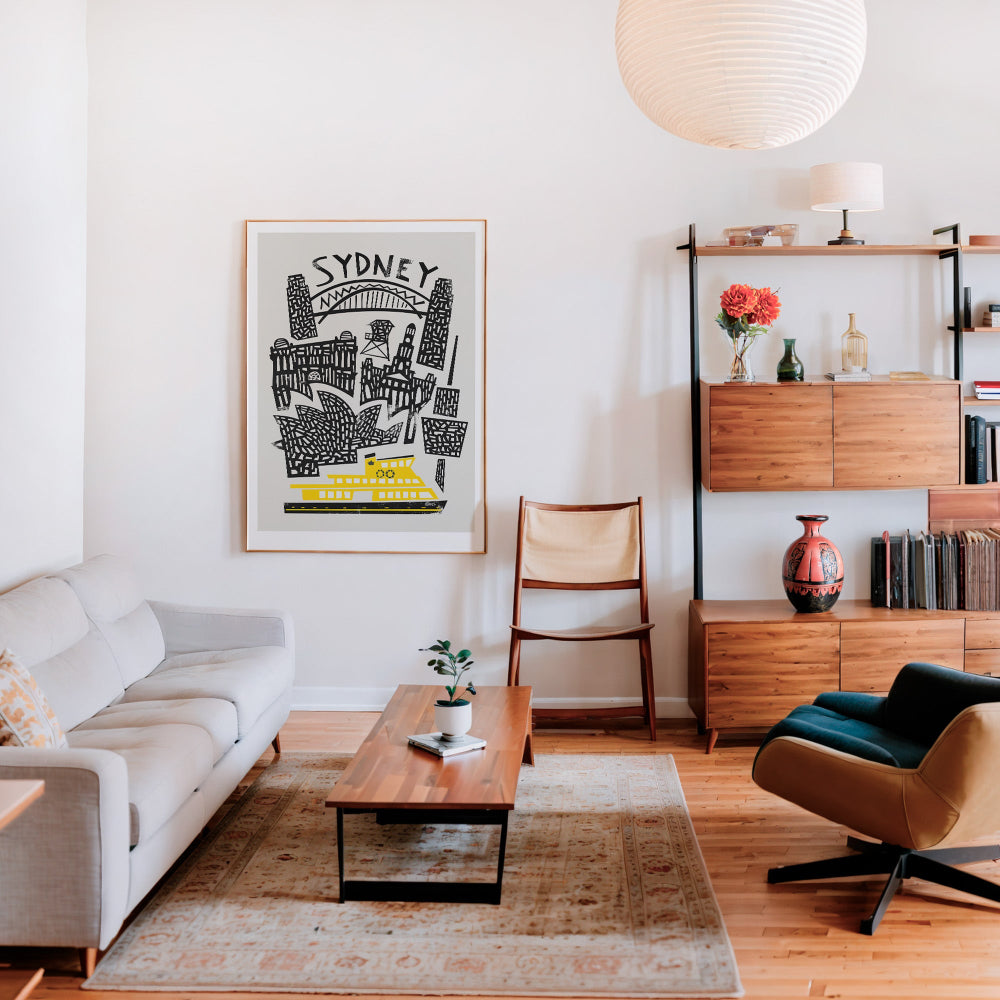 Framed retro Sydney skyline poster brightening a modern living-room gallery wall.