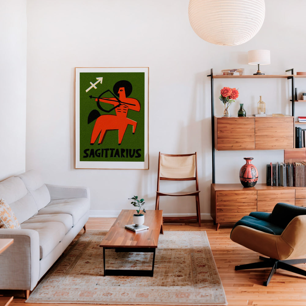 Sagittarius zodiac artwork framed above a cream sofa in a mid-century style living room with wood and rattan accents.