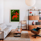Sagittarius zodiac artwork framed above a cream sofa in a mid-century style living room with wood and rattan accents.