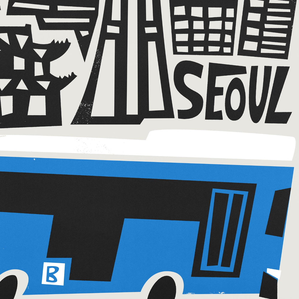 Close-up of Seoul city print showing abstract skyline shapes and the graphic blue bus with bold contrast.