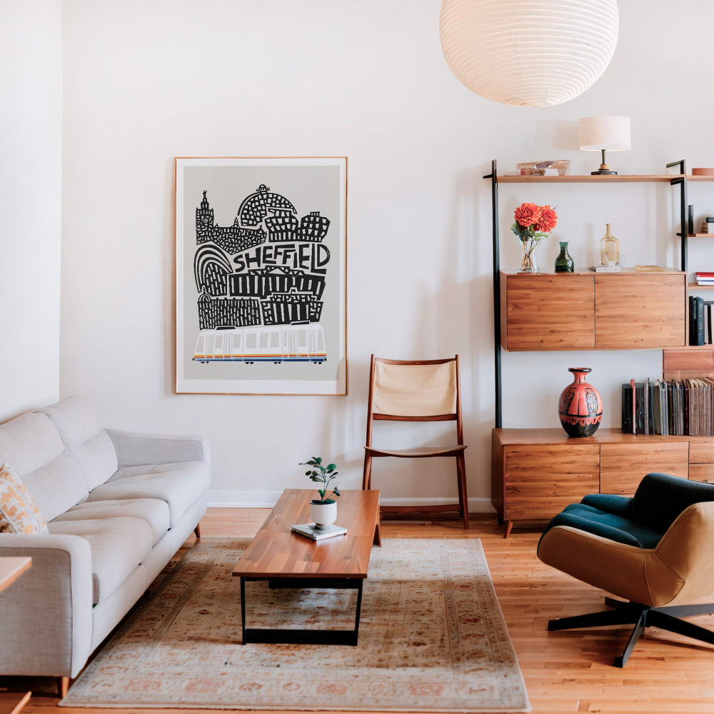 The Sheffield art print displayed above a stylish wooden sideboard, bringing a sense of place and urban personality to a mid-century modern lounge interior.