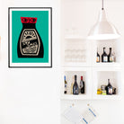 Soy Sauce poster framed above open shelving with bottles and barware in a bright white kitchen nook.