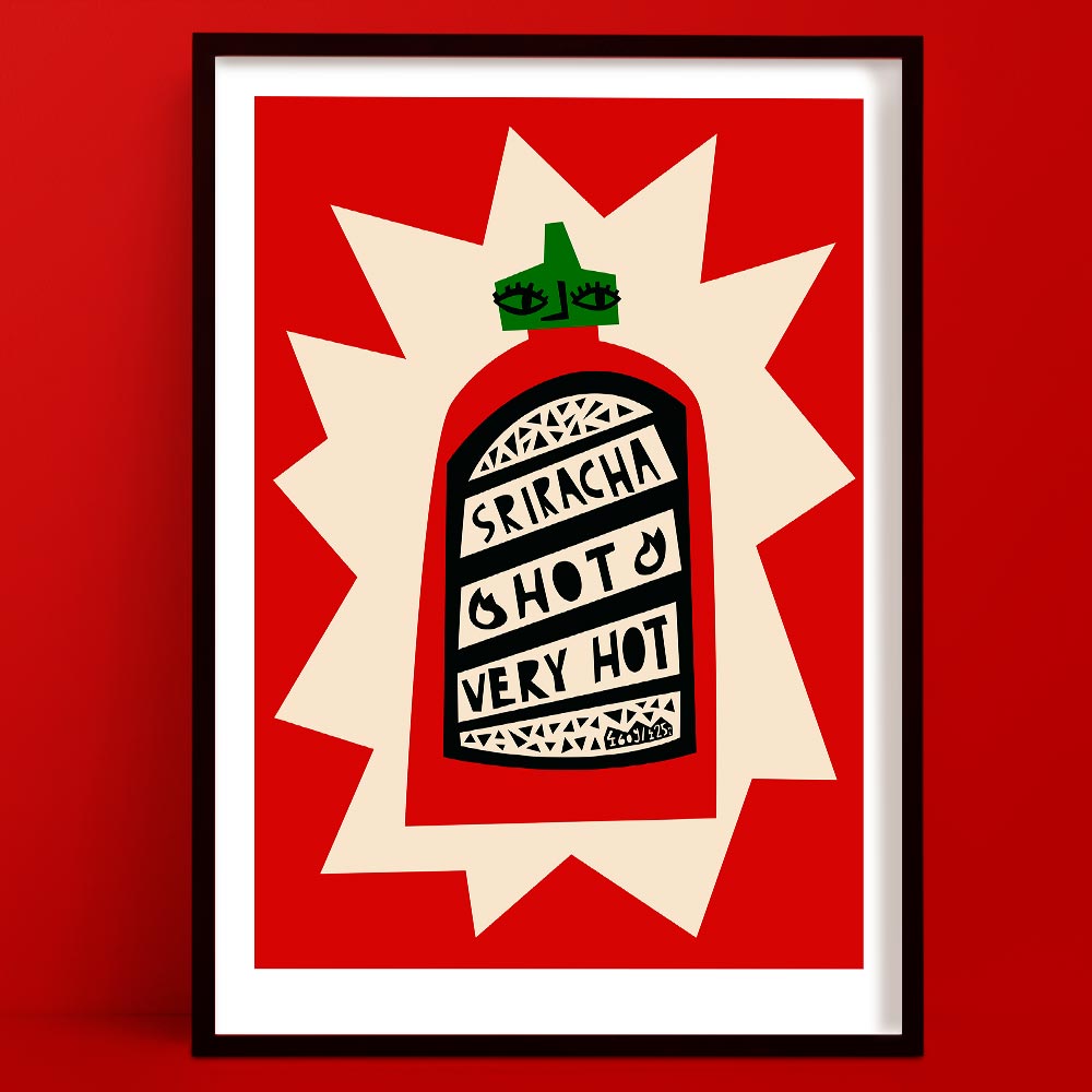 Sriracha art print featuring a graphic red bottle with hand-lettered label and bold burst backdrop, framed on red wall.