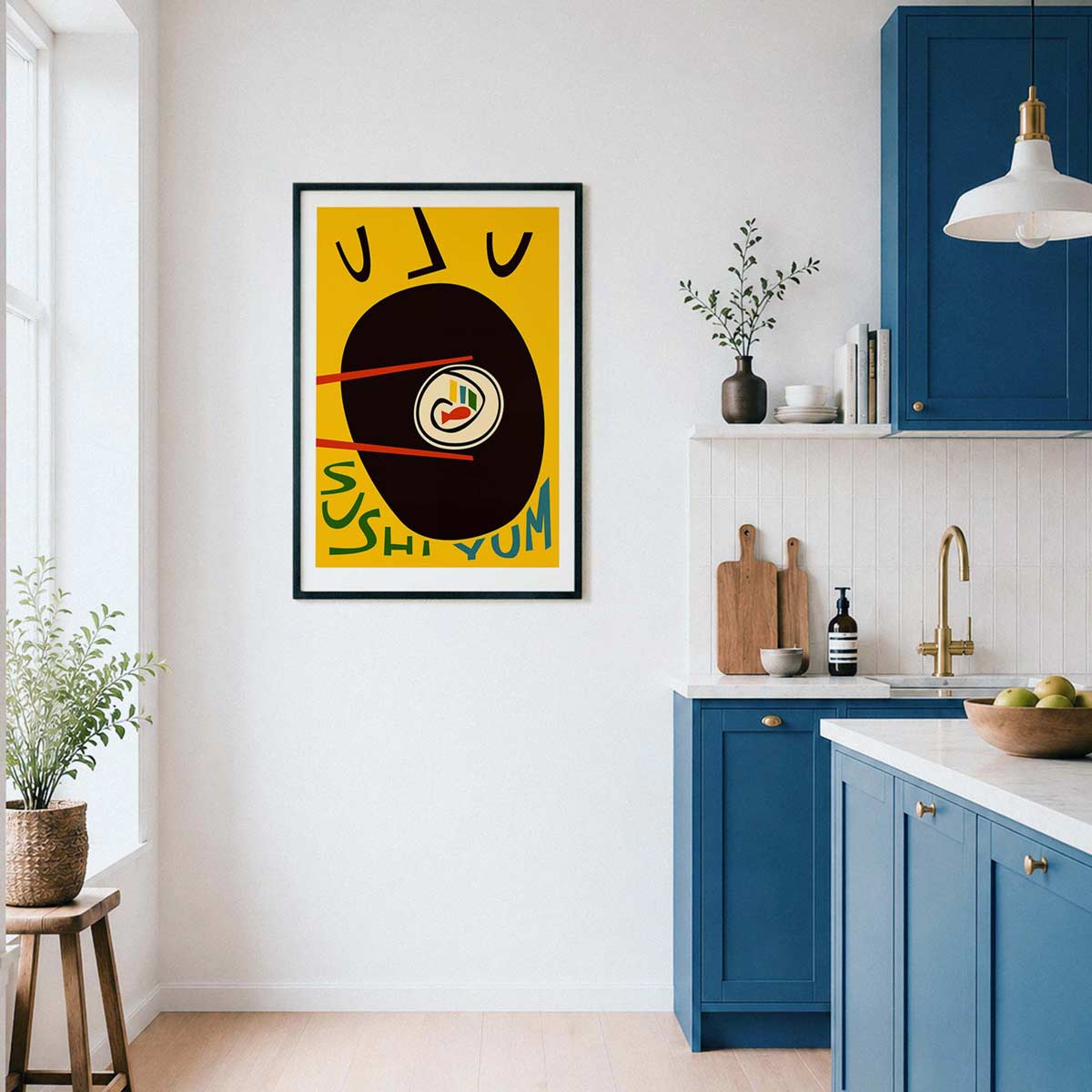 A framed abstract art print featuring a yellow background, a large black circle, and stylized text hangs on a white wall in a modern kitchen with blue cabinets.