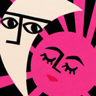 Close-up of The Lovers artwork showing the expressive moon and sun faces—his gaze watchful, hers peaceful—with strong black linework and radiant pink rays framing the composition.
