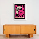 The Lovers print displayed in a minimalist room with a low wooden cabinet, its vivid magenta background and symbolic design bringing bold, romantic energy to the space.
