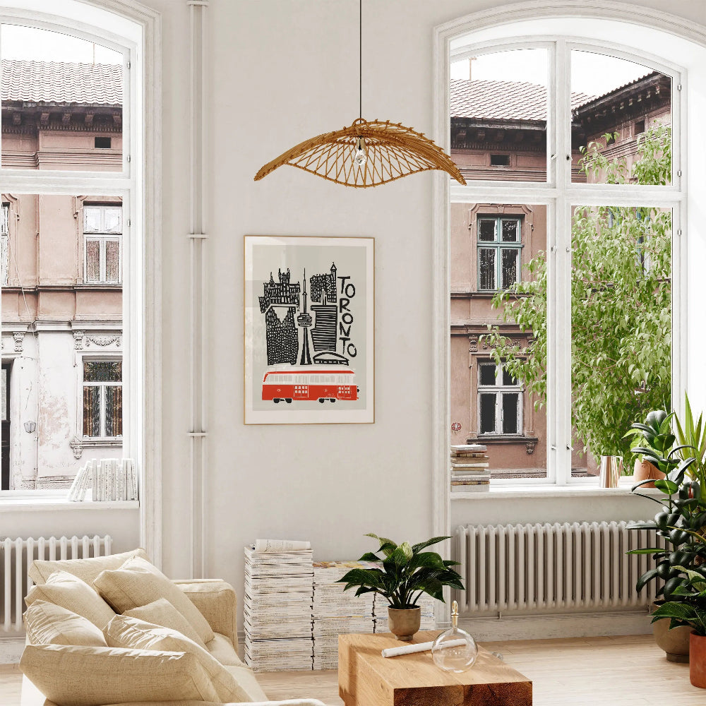 Framed Toronto city print hung in a bright, plant-filled room with large windows—an eye-catching urban print that adds modern flair with a vintage twist.
