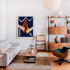 Virgo artwork framed above a cream sofa in a cosy, mid-century styled lounge with wood accents and paper lantern.