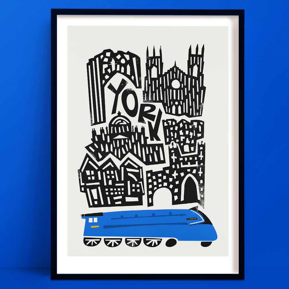 Illustrated York city art print showing a graphic skyline of historic buildings above a bright blue train, framed on a bold blue wall.