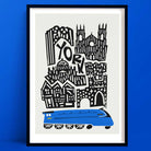 Illustrated York city art print showing a graphic skyline of historic buildings above a bright blue train, framed on a bold blue wall.