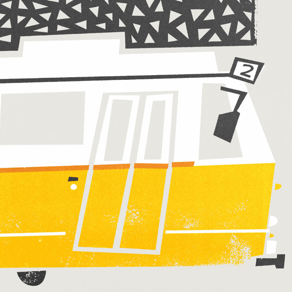 A close-up of the Budapest print showcasing the textured yellow tram and crisp architectural line work.