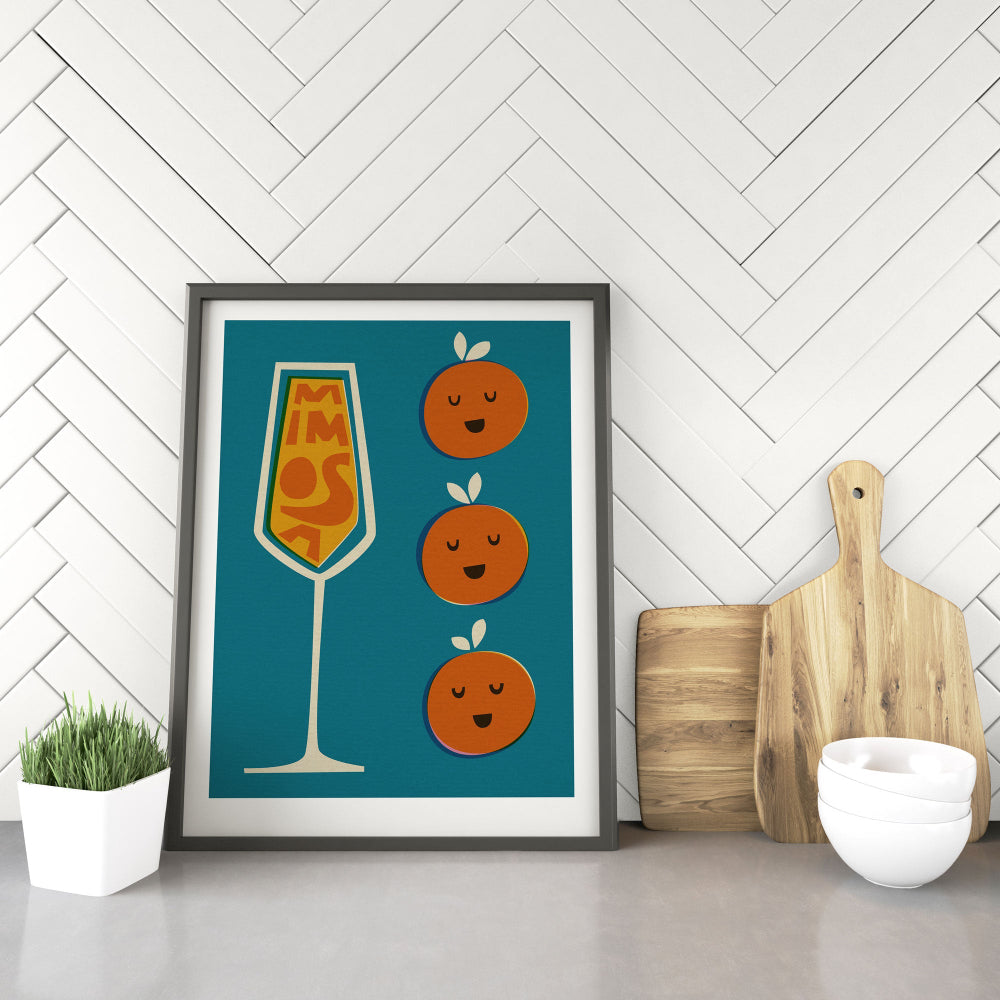 Mimosa print framed on the floor next to pale wooden boards and chopping blocks in a bright, modern kitchen corner.