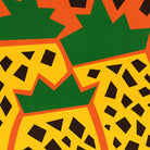Zoomed-in view of the pineapple shapes and chunky black text, with bold green tops and warm golden yellow patterning.